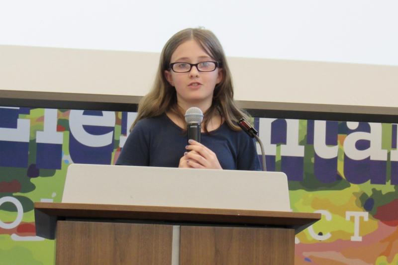 Third-grader Lorelei Moore presents in both Spanish and English.